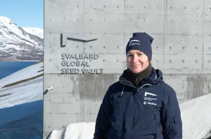 Woman outside, mountain in the background.