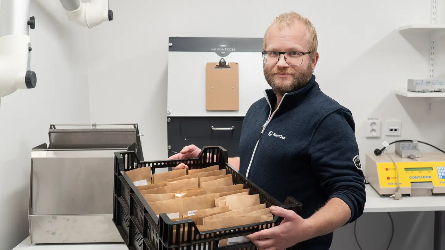 Man holding seeds.