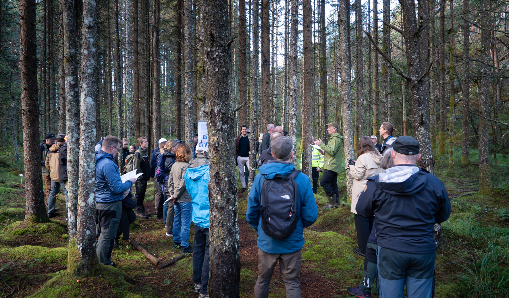 Man talking in front of a crowd. 
