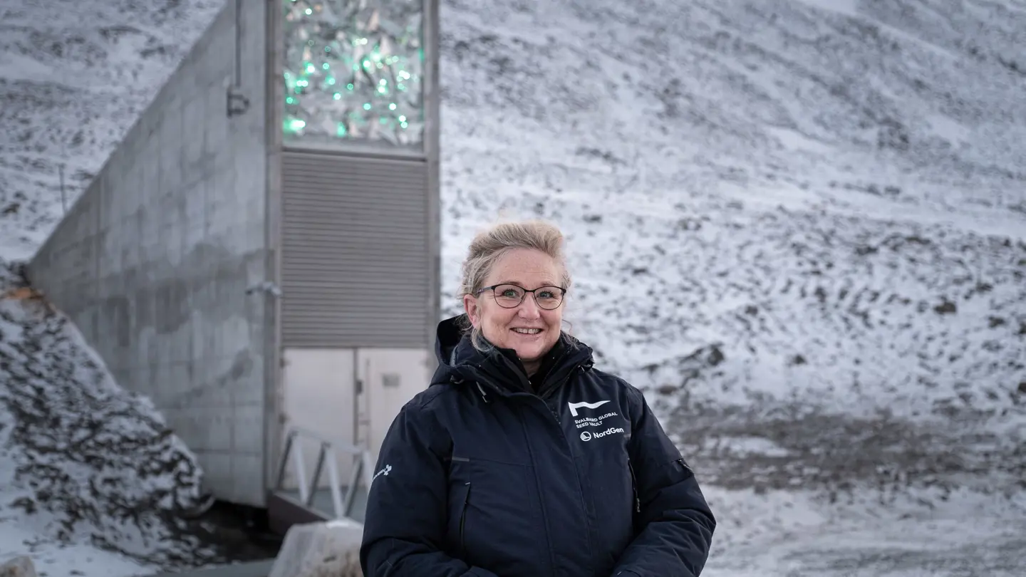 Woman standing outside a concrete building