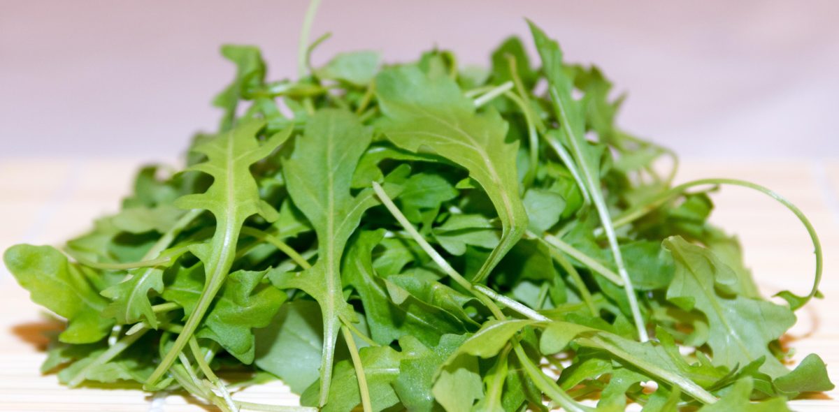 A pile of green salad leaves lying on a table