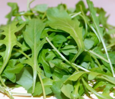 A pile of green salad leaves lying on a table