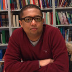 Portrait of researcher with bookcase in the background